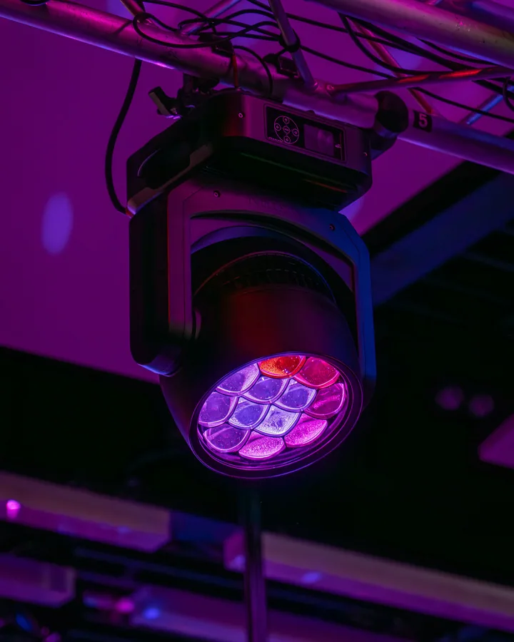Moving-head LED fixture rigged to a truss in a permanent installation.