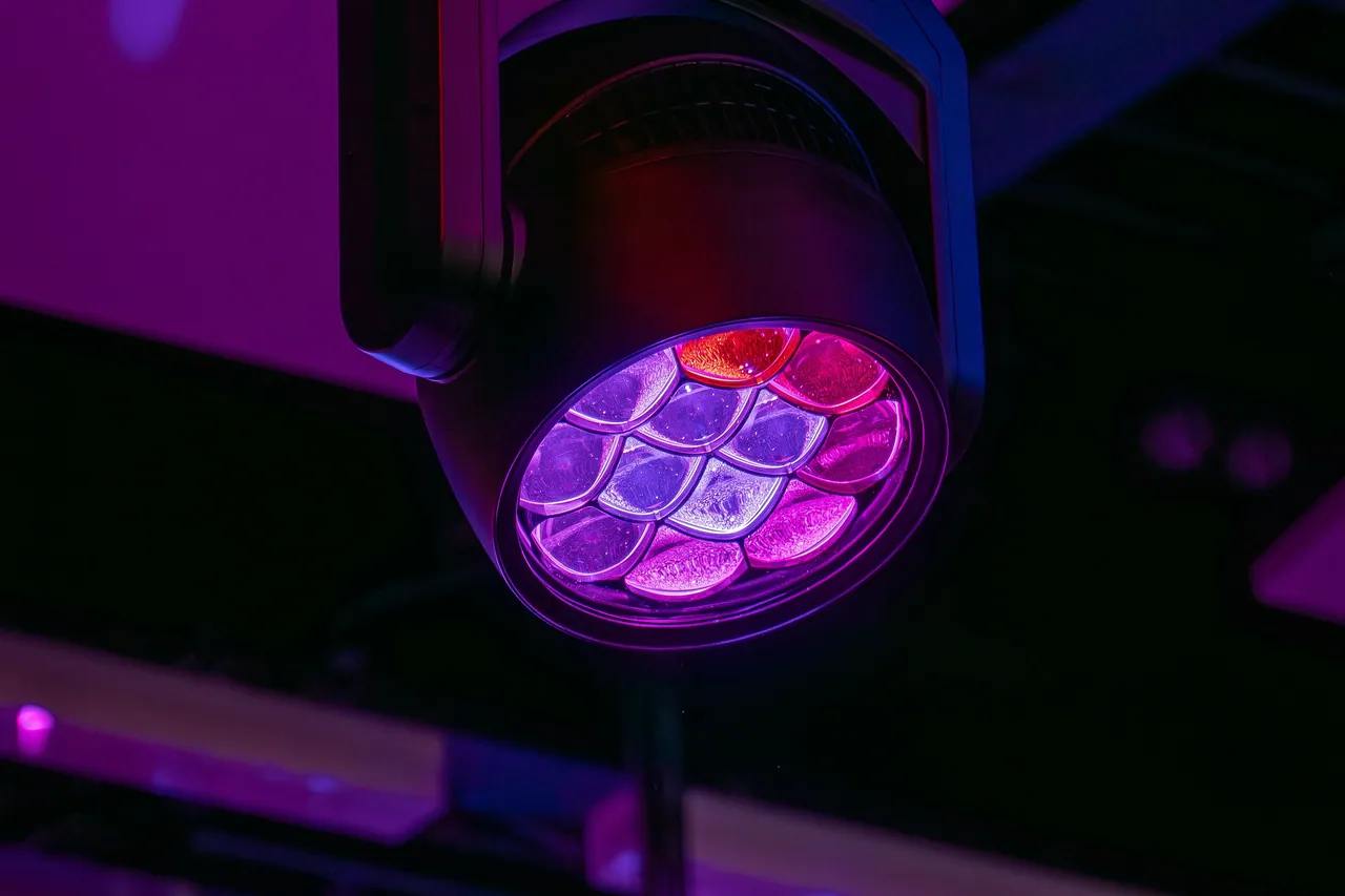 Moving-head LED fixture rigged to a truss in a permanent installation.
